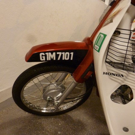 Glorious One Malaysia seen, unusually, on a moped in Penang Feb. 2013.   Usually borne by Porsches and Bentleys!    Maybe a tender to a Malaysian yacht.....