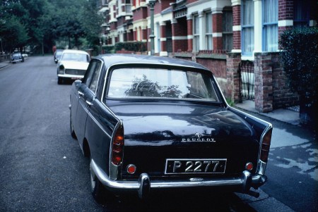 St. Vincent, the rarest of the W set of Windward Islands, seen in London in 1969, and still the only one ever.    The owner had to be stopped and asked, to learn the island of source.    Peugeot 404 - Brumby archive.