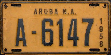 When I saw this, I had to visit the library to find out where 'Aruba' was to be found on an atlas!.    Some weeks after seeing the Ford 100E Anglia at Hyde Park Corner, I saw VXD 44 parked in Fulham from the top of my RT double-decker.     Swiftly dismounting, I hunted the owner, in the sure belief it was the Aruban, recently re-registered in Britain.   It was, and the amused owner handed me one of his plates, which I still value among the most unusual plates in my collection.