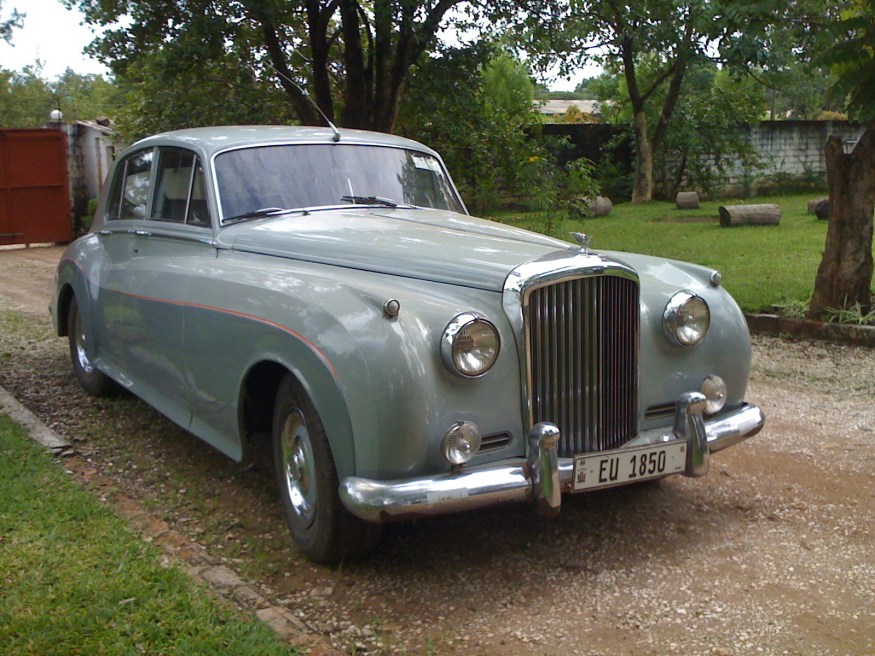 A yet newer adoption of an earlier=series registration is EU 1850, borne on a Bentley S3 from the '60s. EU would originally have been issued on the British design of plate, in white on black, but has been re-issued using the current Zambian format.